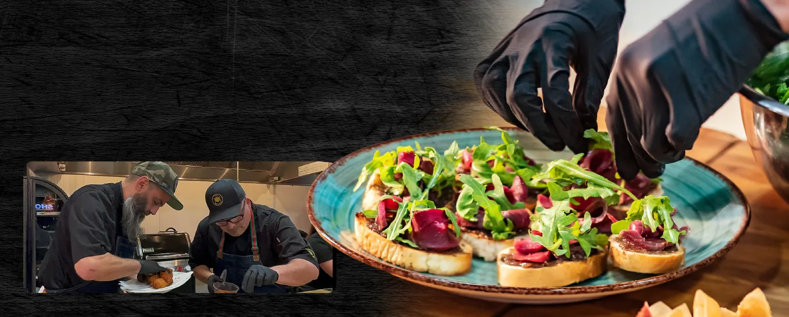 Chef assembling bread slices with rocket and shaved meat on top